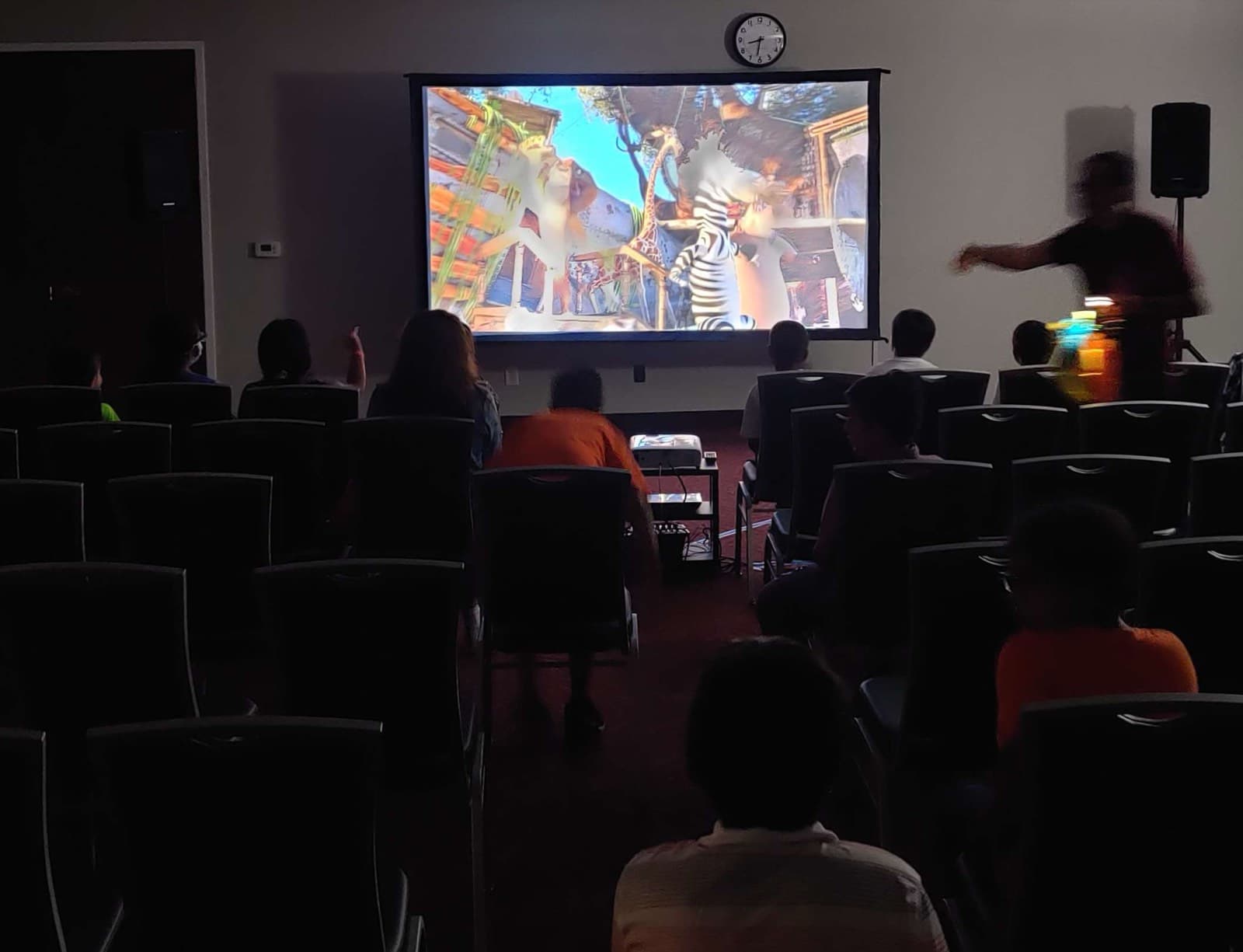 Indoor movie screening with a rented HD projector and fast-fold screen for a full audience at an Orange County event